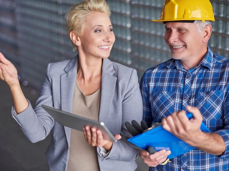 Manager with manual worker in warehouse